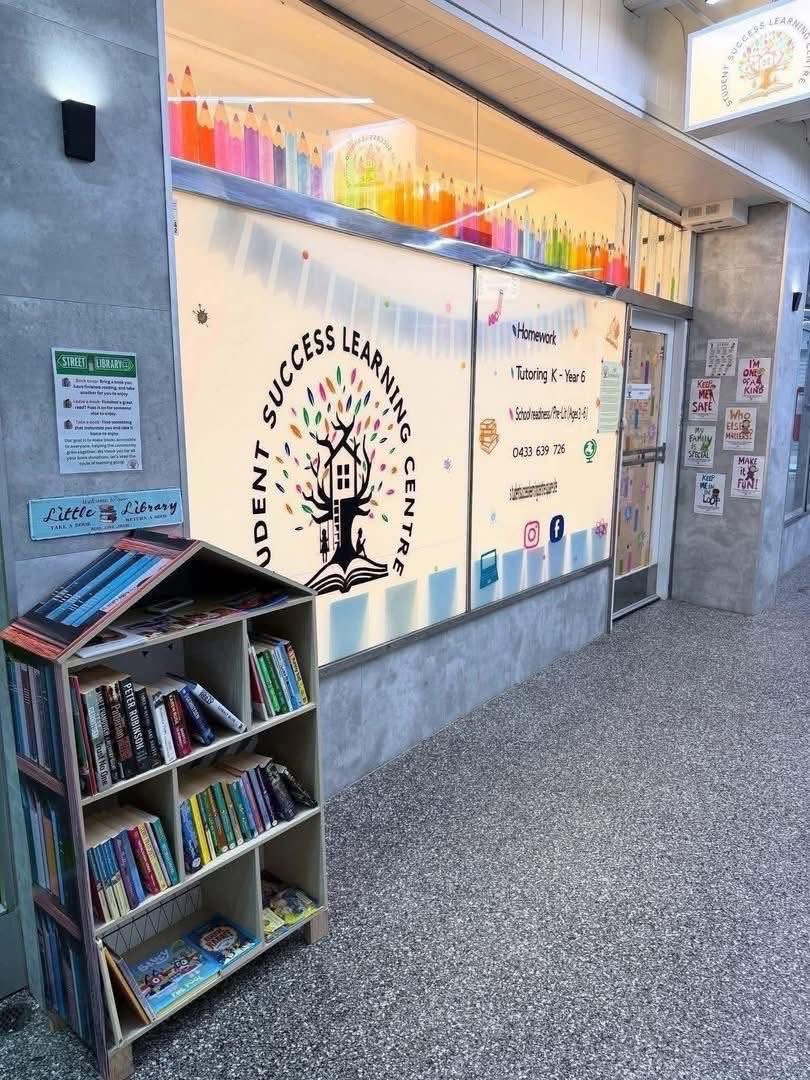 Student Success Learning Centre storefront with colourful pencil display, little library bookshelf and tutoring services signage